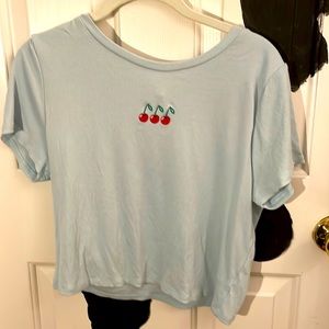 Blue shirt with cherries on it